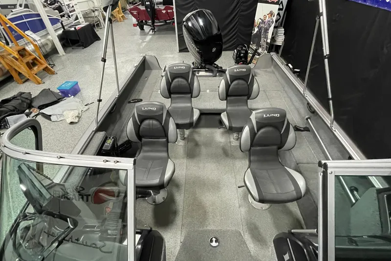 Slide: The Image of 2018 Lund 1875 Impact Sport boat interior with four seats and motor. - 8