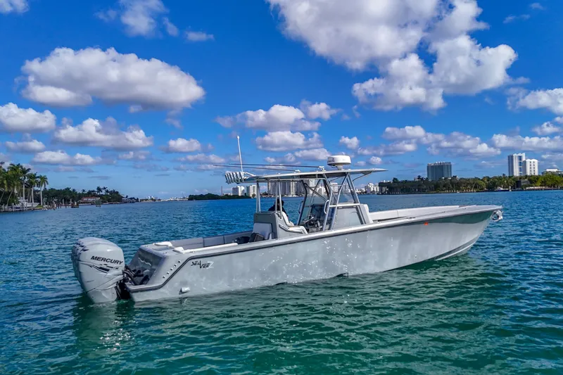The Image of 2018 SeaVee 390Z boat on clear blue water under a partly cloudy sky. - 0