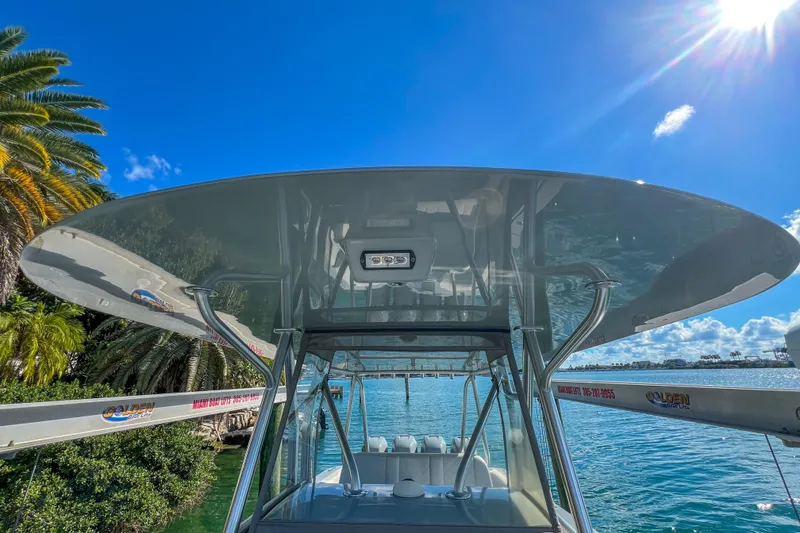 Slide: The Image of 2018 SeaVee 390Z boat with T-top, docked under clear blue sky. - 13