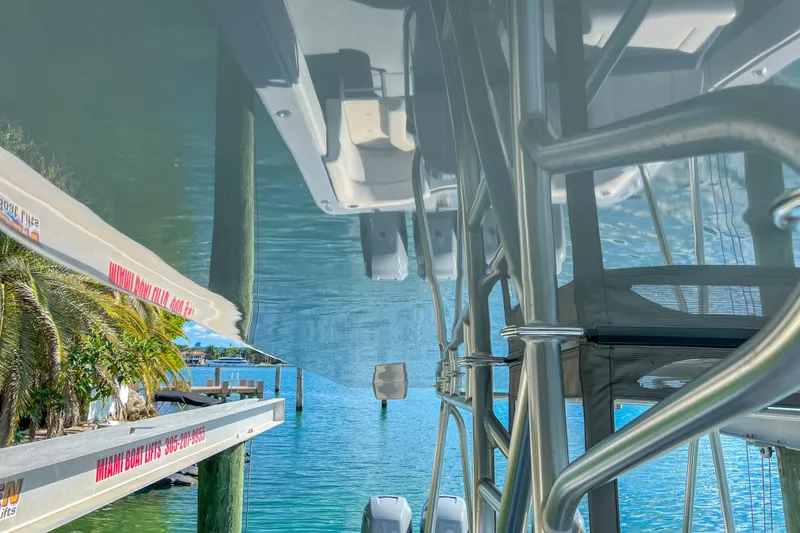 Slide: The Image of Upside-down view of a 2018 SeaVee 390Z boat on a lift by the water. - 14