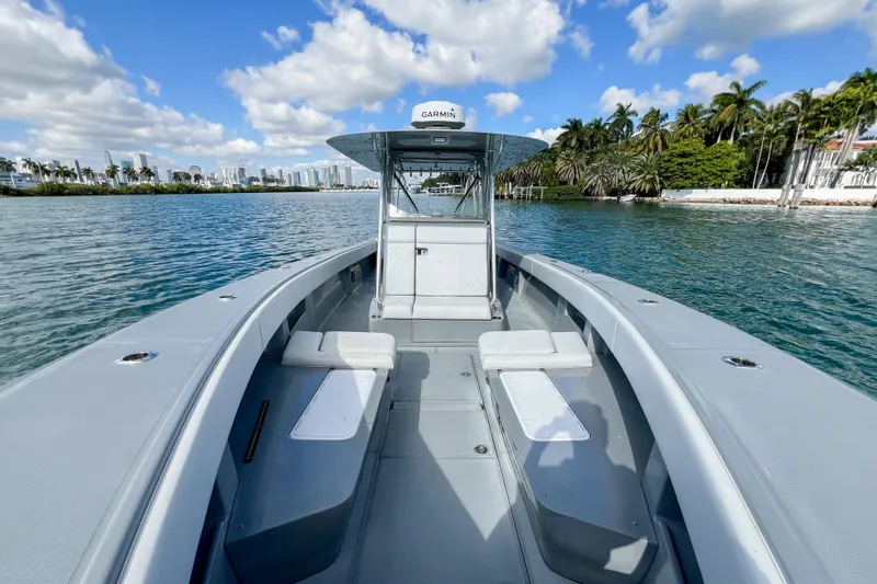Slide: The Image of 2018 SeaVee 390Z boat on calm water, clear sky, city skyline in background. - 16