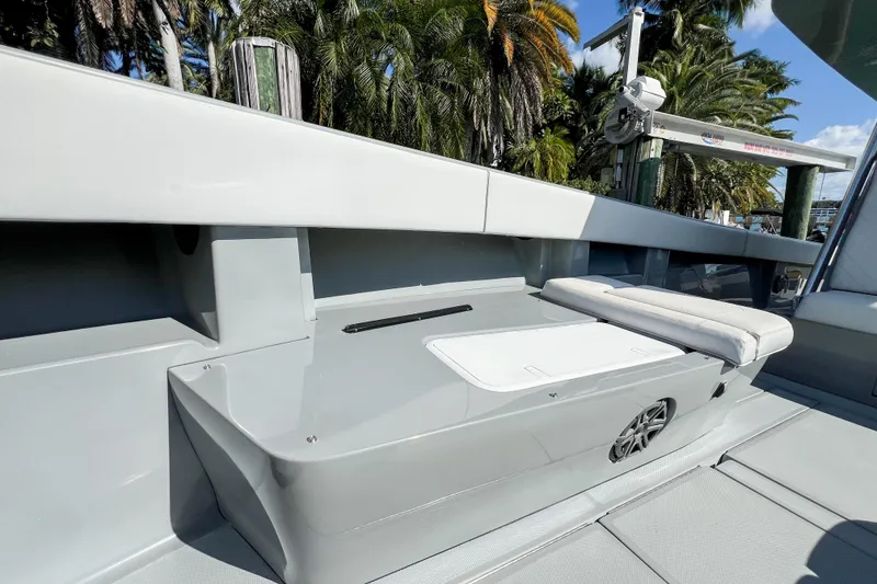 Slide: The Image of 2018 SeaVee 390Z boat interior with seating, sleek design, and tropical background. - 18