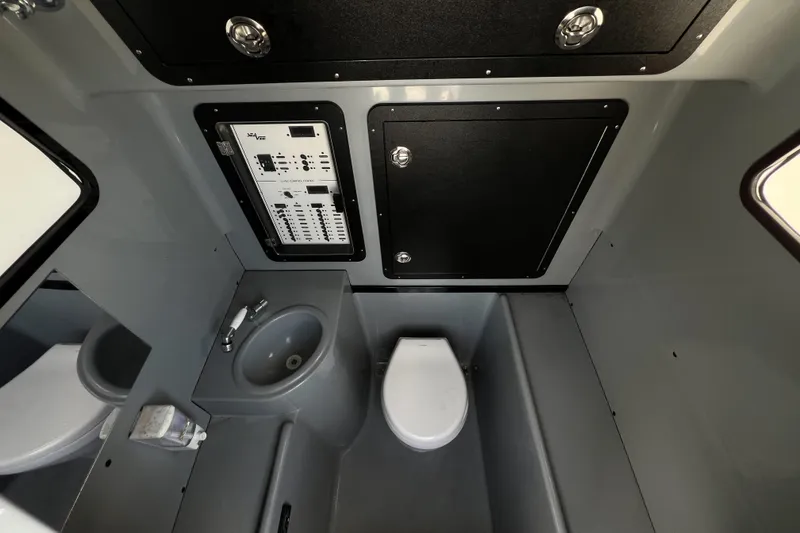 Slide: The Image of 2018 SeaVee 390Z boat interior with toilet, sink, and control panel. - 19