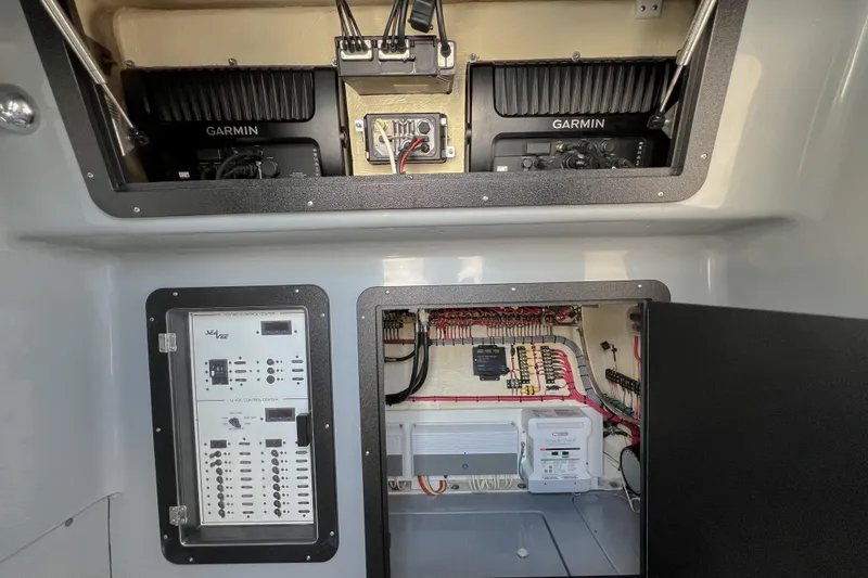 Slide: The Image of Electrical panel and Garmin systems inside a 2018 SeaVee 390Z boat. - 21