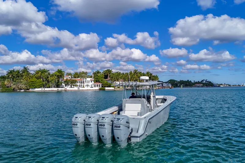 Slide: The Image of 2018 SeaVee 390Z boat with four engines on a sunny day, near a tropical shoreline. - 23