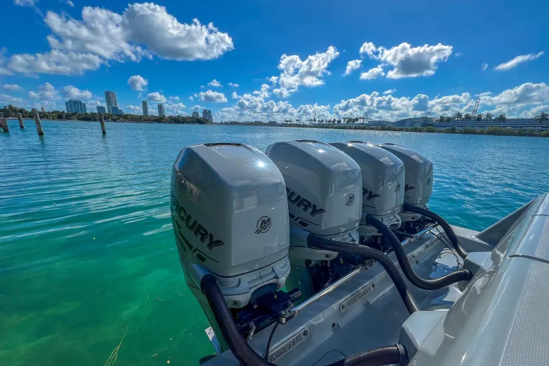 Slide: The Image of 2018 SeaVee 390Z boat with four Mercury outboard engines on a sunny waterfront. - 5