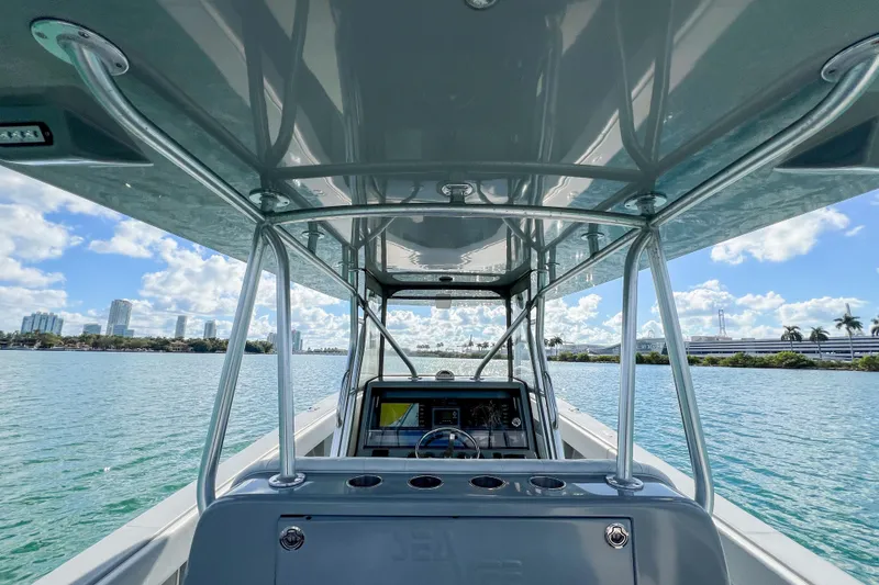 Slide: The Image of 2018 SeaVee 390Z boat on water, city skyline in background, sunny day. - 8