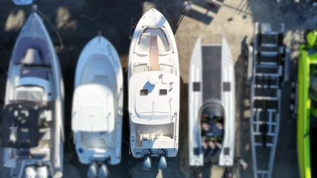 Slide: The Image of Aerial view of boats docked, featuring a 2013 Grady-White Freedom 335. - 11