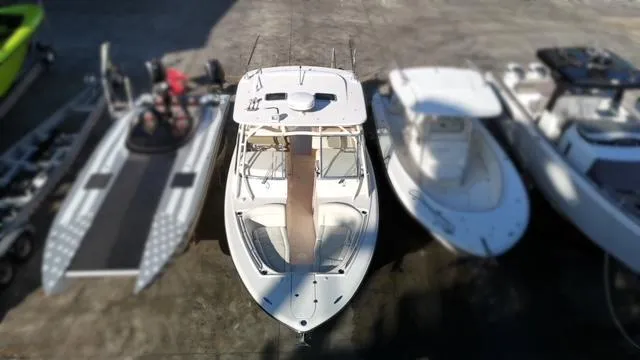 Slide: The Image of 2013 Grady-White Freedom 335 boat docked among other vessels. - 13