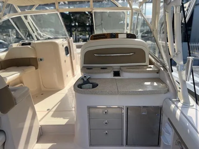 Slide: The Image of 2013 Grady-White Freedom 335 boat interior with seating and kitchenette area. - 15