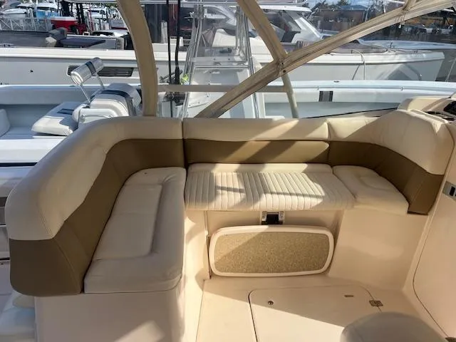 Slide: The Image of 2013 Grady-White Freedom 335 boat interior with cushioned seating area. - 16