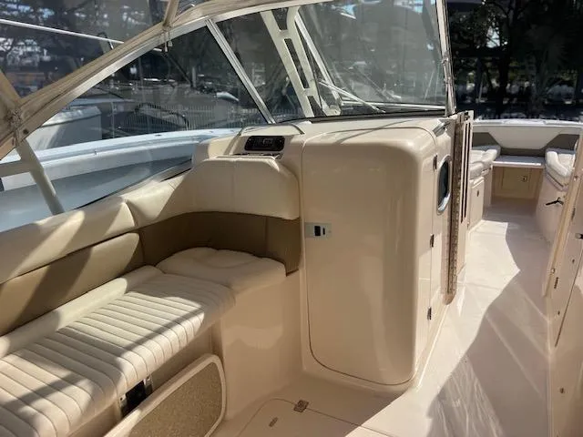 Slide: The Image of 2013 Grady-White Freedom 335 boat interior with beige seating and helm area. - 17