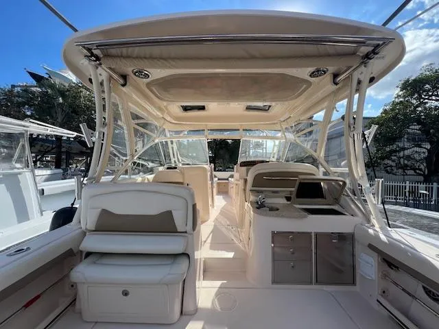 Slide: The Image of 2013 Grady-White Freedom 335 boat interior with seating and helm station. - 22