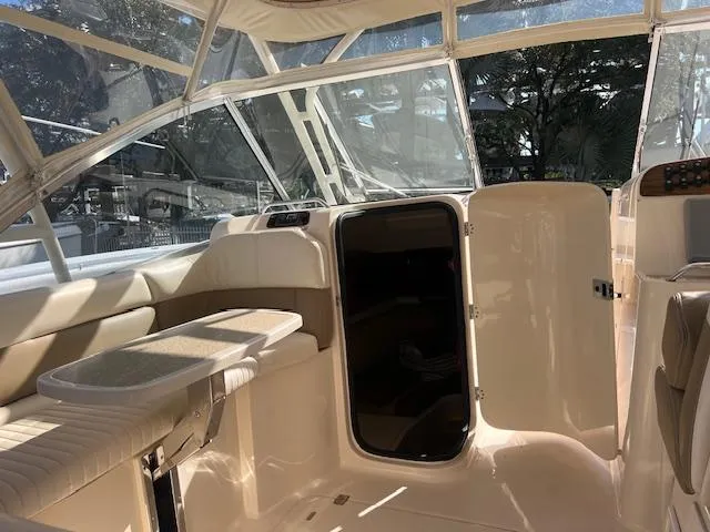 Slide: The Image of 2013 Grady-White Freedom 335 boat interior with seating and open cabin door. - 26