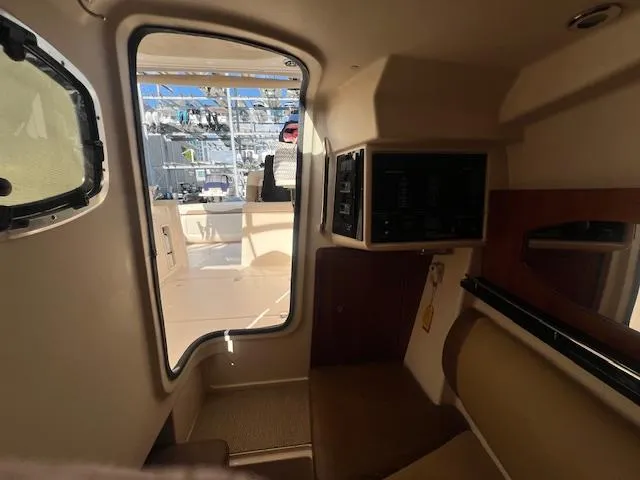 Slide: The Image of Interior view of 2013 Grady-White Freedom 335 boat cabin with seating and window. - 27