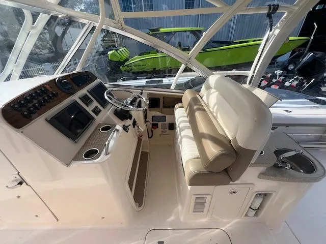 Slide: The Image of 2013 Grady-White Freedom 335 boat interior with helm, seating, and controls. - 32