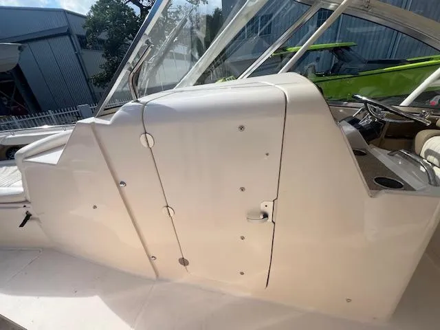 Slide: The Image of 2013 Grady-White Freedom 335 boat interior, featuring sleek white console design. - 33