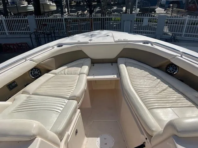 Slide: The Image of 2013 Grady-White Freedom 335 boat interior with cushioned seating and speakers. - 37