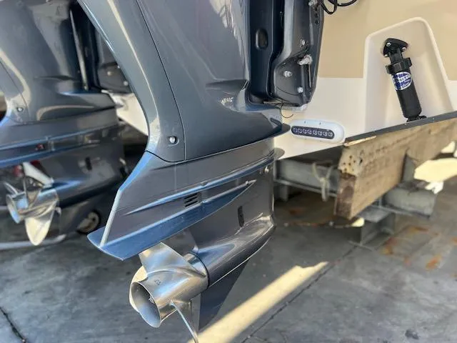 Slide: The Image of 2013 Grady-White Freedom 335 boat with dual outboard motors in a marina setting. - 45