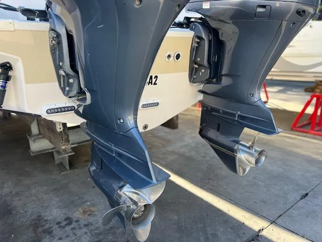 Slide: The Image of Twin outboard motors on a 2013 Grady-White Freedom 335 boat, docked on a concrete surface. - 46