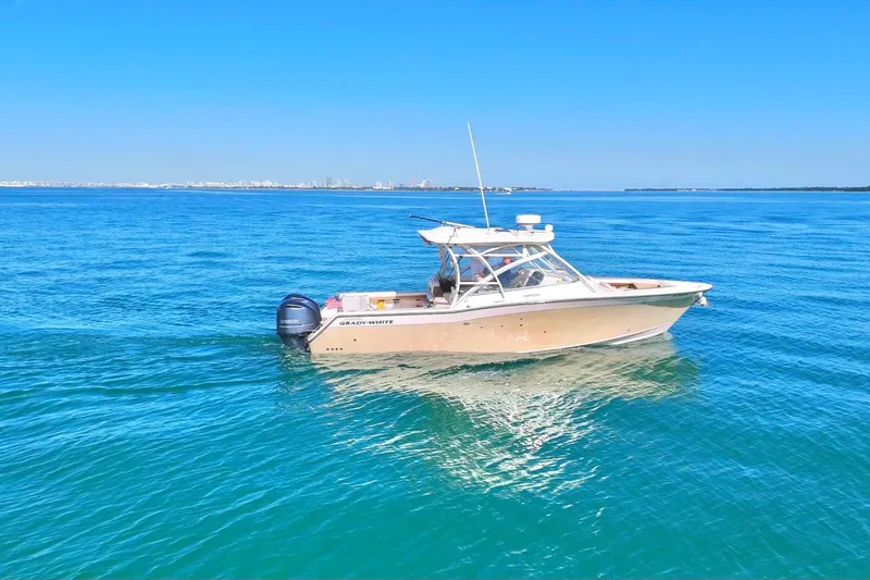 Slide: The Image of 2013 Grady-White Freedom 335 boat on calm blue ocean waters. - 7
