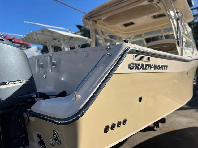 Slide: The Image of 2013 Grady-White Freedom 335 boat, rear view, showcasing sleek design and powerful engine. - 8