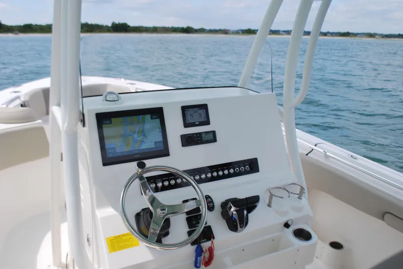 Slide: The Image of 2022 Key West 263 FS boat dashboard with navigation system on open water. - 11