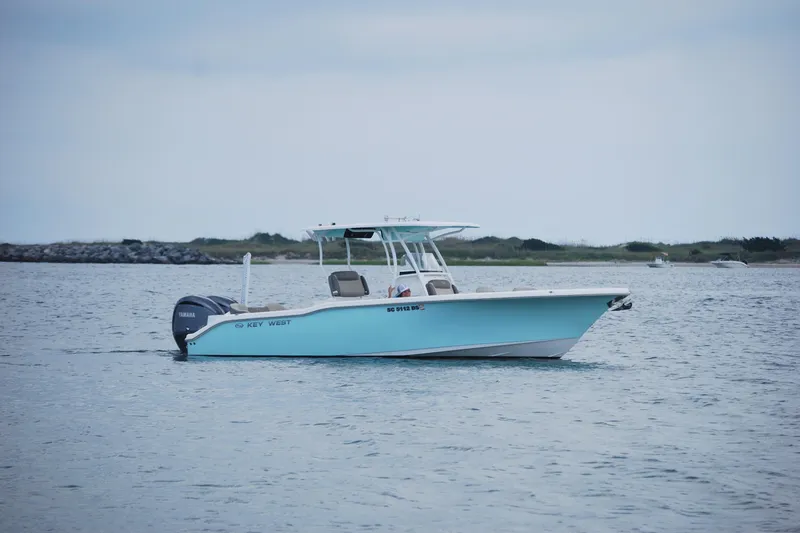 Slide: The Image of 2022 Key West 263 FS boat on calm water, overcast sky. - 3