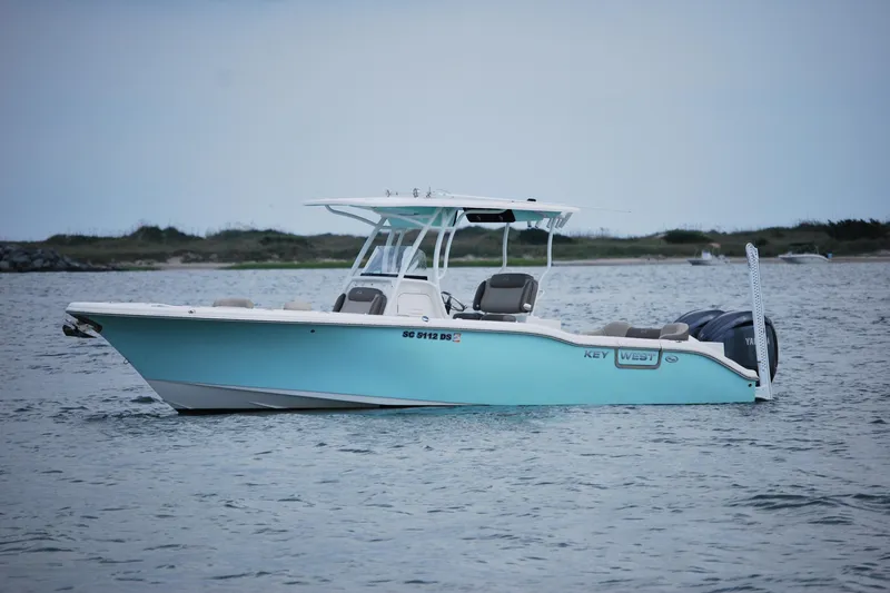 Slide: The Image of 2022 Key West 263 FS boat on calm water, side view. - 4