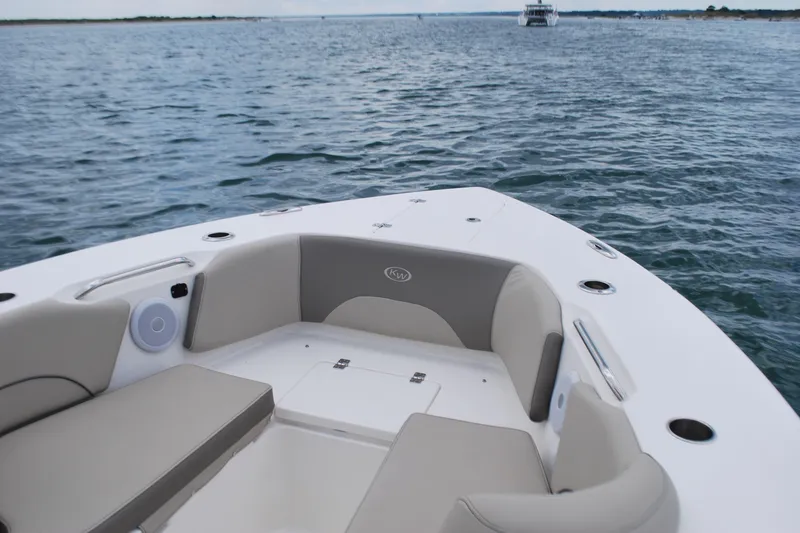 Slide: The Image of 2022 Key West 263 FS boat interior with cushioned seating on open water. - 8