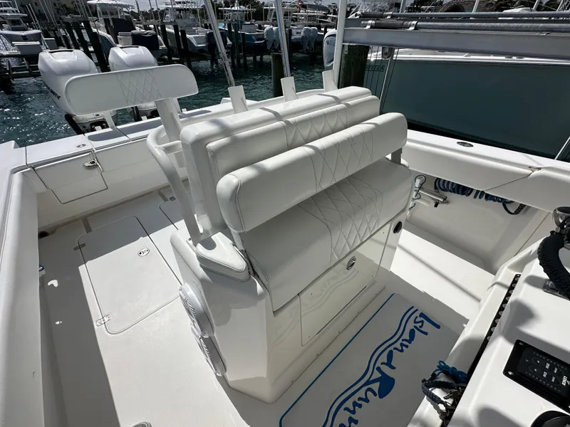 Slide: The Image of 2006 Island Runner 35 boat interior with white seating and helm station. - 17
