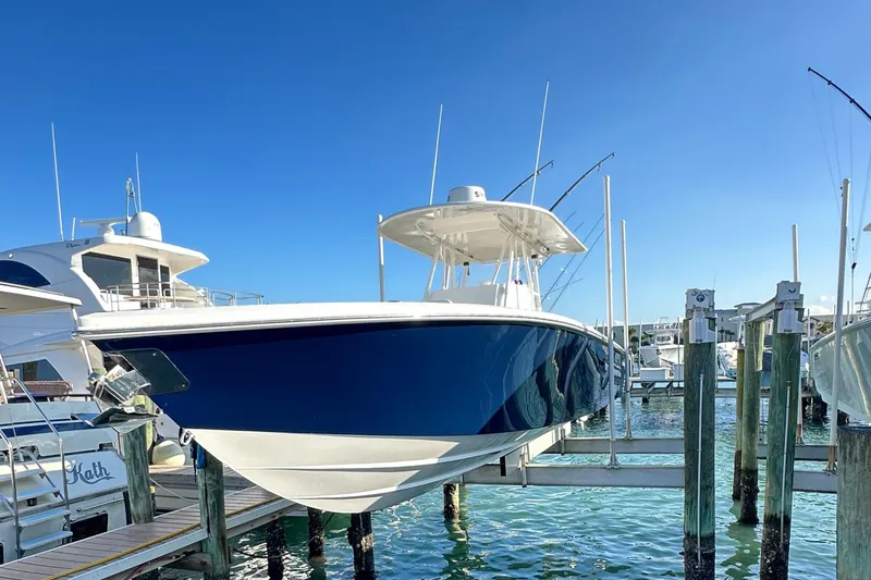 Slide: The Image of 2006 Island Runner 35 boat docked at marina under clear blue sky. - 2