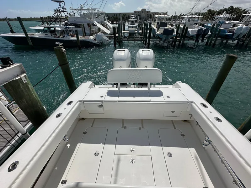 Slide: The Image of 2006 Island Runner 35 boat docked at marina, featuring spacious deck and twin engines. - 21
