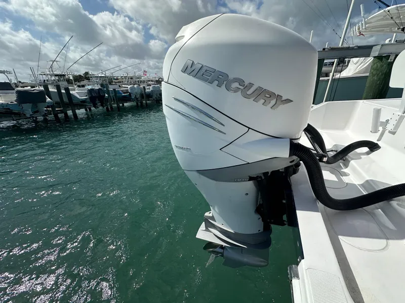 Slide: The Image of Mercury outboard motor on 2006 Island Runner 35 boat, docked in marina. - 24