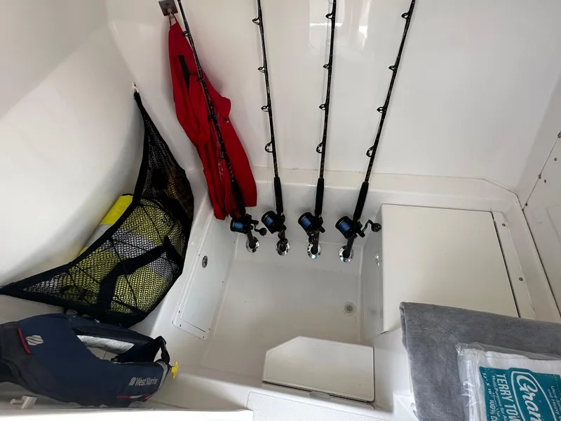 Slide: The Image of 2006 Island Runner 35 boat interior with fishing rods and safety gear. - 34