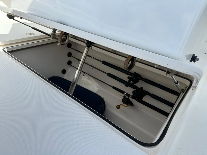 Slide: The Image of Open storage compartment on 2006 Island Runner 35 boat with fishing rods. - 42