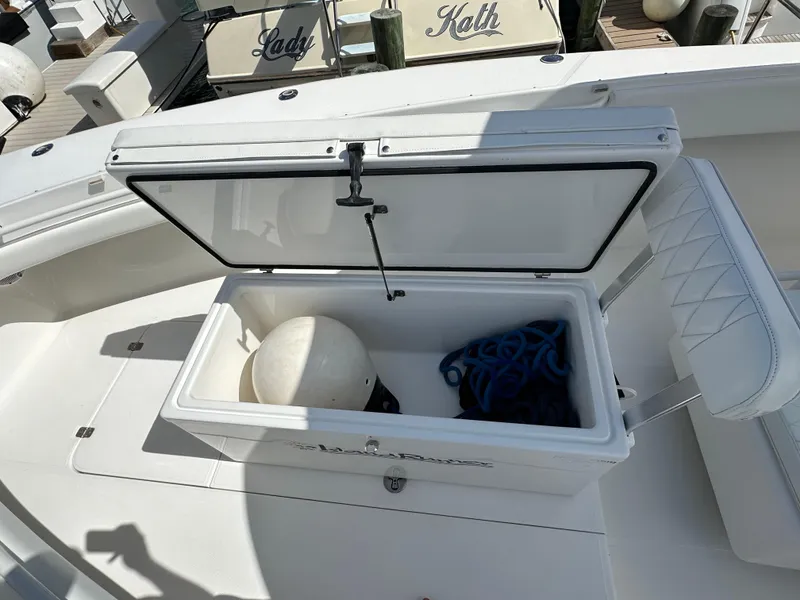 Slide: The Image of Open storage compartment on 2006 Island Runner 35 boat with marine equipment inside. - 47
