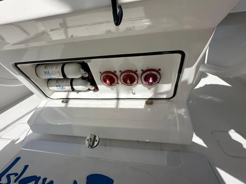 Slide: The Image of Control panel of a 2006 Island Runner 35 boat with fire extinguishers and switches. - 9