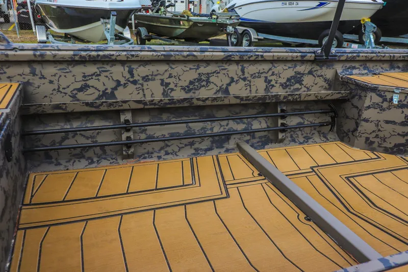 Slide: The Image of 2026 Gator Tail 17/50 MID-DECK SAVAGE SERIES boat interior with camouflage design and wooden flooring. - 10