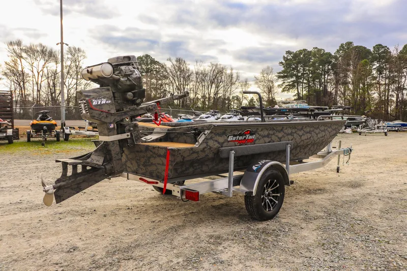 Slide: The Image of 2026 Gator Tail 17/50 MID-DECK SAVAGE SERIES boat on trailer, outdoor setting. - 4