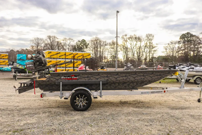 Slide: The Image of 2026 Gator Tail 17/50 MID-DECK SAVAGE SERIES boat on trailer, outdoor display. - 5