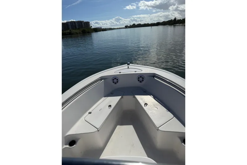 Slide: The Image of 2020 Tidewater 198 CC Adventure boat on calm water, sunny day, scenic view. - 7