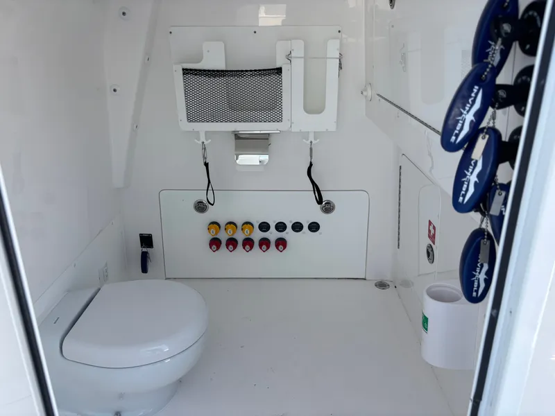 Slide: The Image of Interior of 2024 Invincible 35 Catamaran featuring toilet and controls. - 21