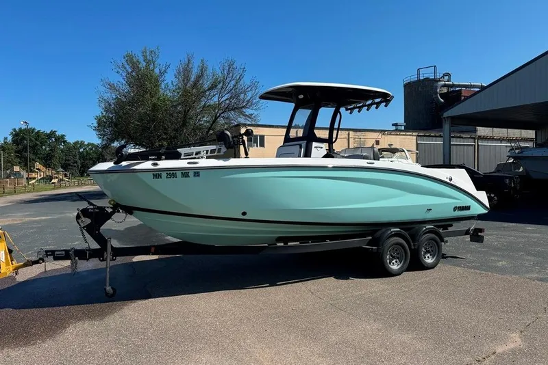 The Image of 2023 Yamaha Boats 255 FSH Sport E on trailer, parked outdoors. - 0