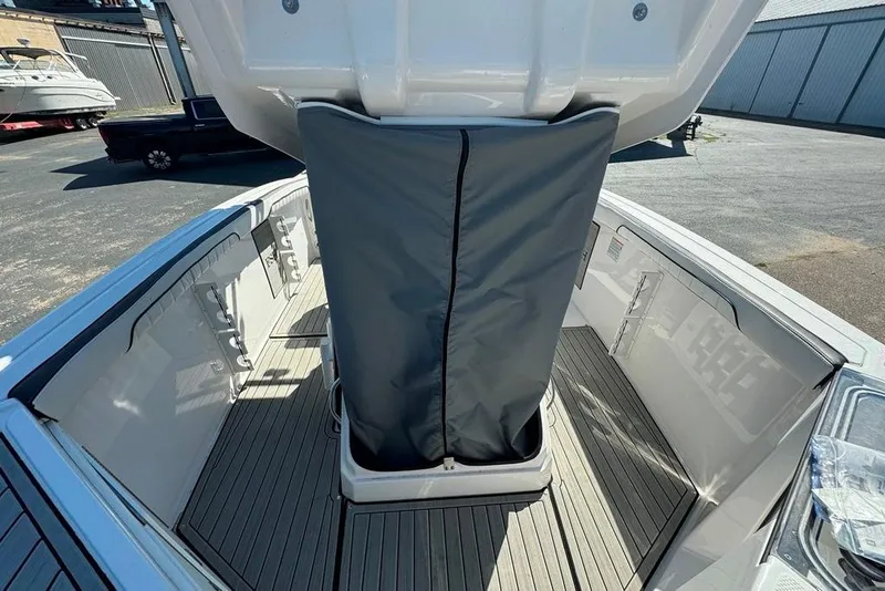 Slide: The Image of 2023 Yamaha Boats 255 FSH Sport E interior with sleek deck and storage cover. - 13