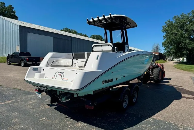 Slide: The Image of 2023 Yamaha Boats 255 FSH Sport E on trailer, parked outdoors. - 18