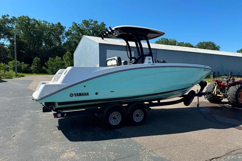 Slide: The Image of 2023 Yamaha Boats 255 FSH Sport E on trailer, parked outdoors. - 19