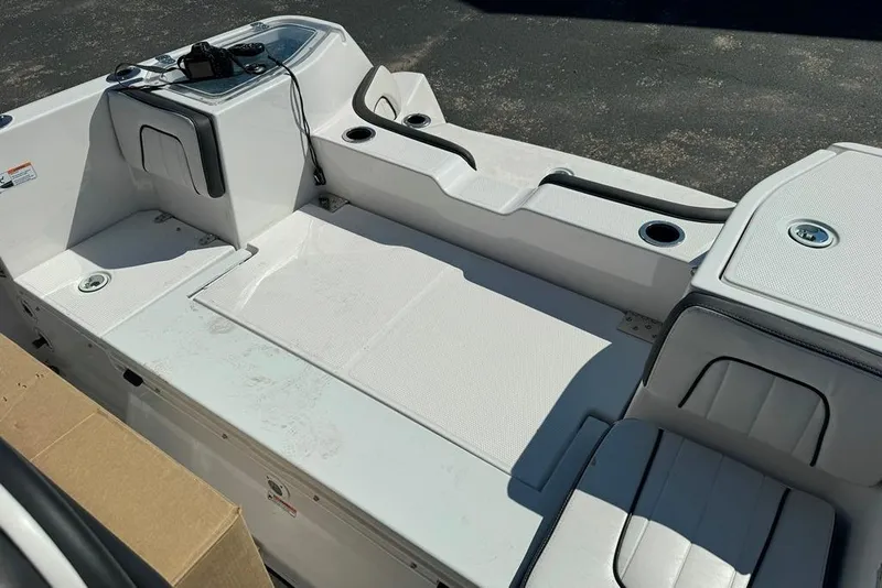 Slide: The Image of 2023 Yamaha Boats 255 FSH Sport E interior with seating and storage compartments. - 4