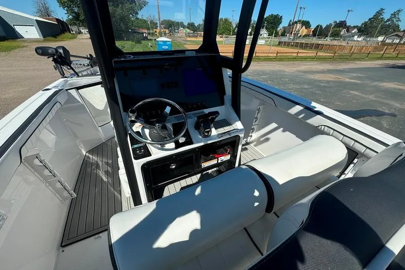 Slide: The Image of 2023 Yamaha Boats 255 FSH Sport E interior with steering console and seating. - 7
