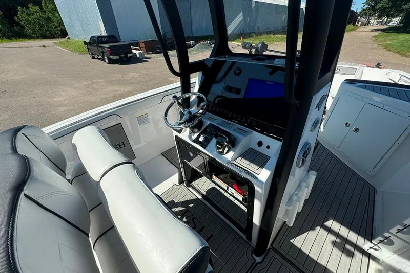 Slide: The Image of 2023 Yamaha Boats 255 FSH Sport E cockpit with modern controls and seating. - 9